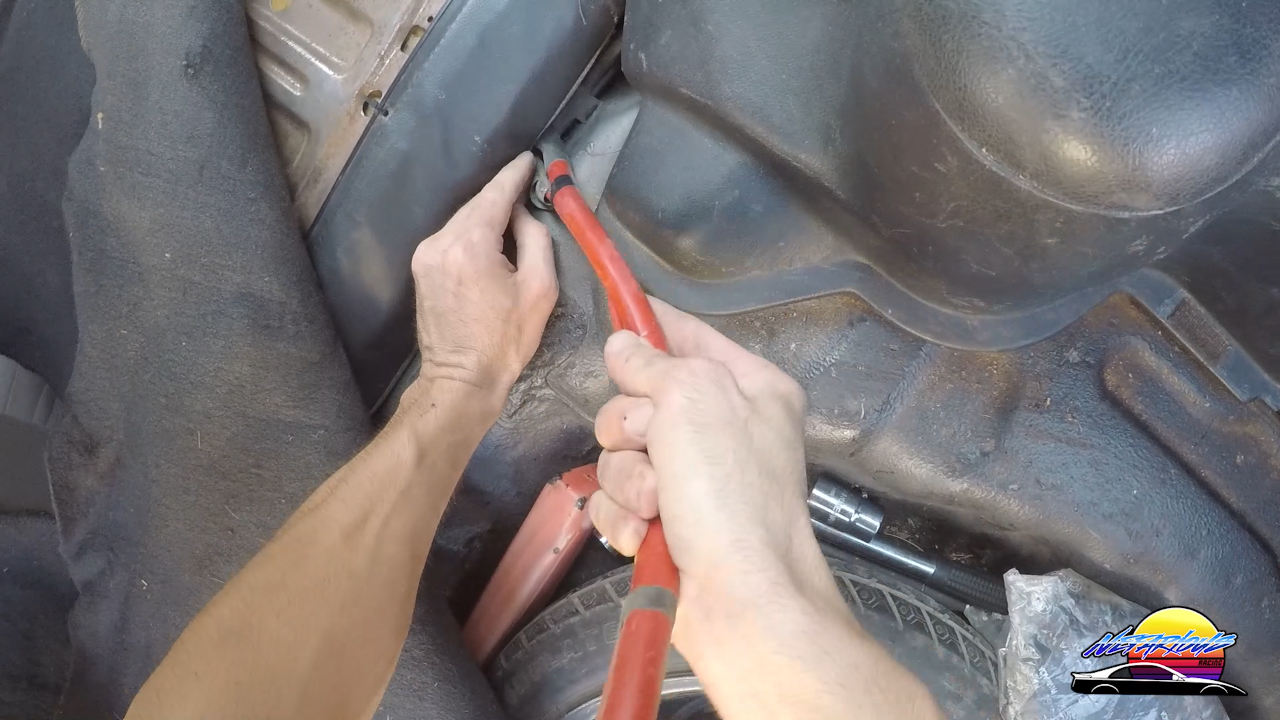 Passing the car battery cable through the car for the battery relocation