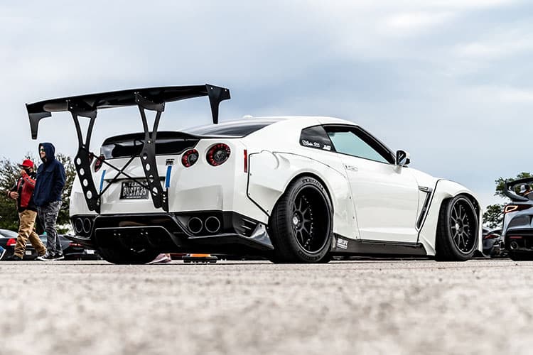White Nissan GTR with staggered wheels