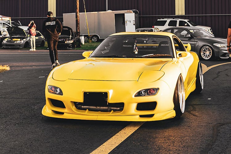 Yellow Mazda RX7 with staggered wheels