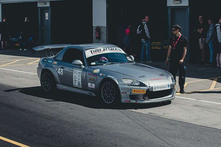Silver Honda S2000 at the pits on a track